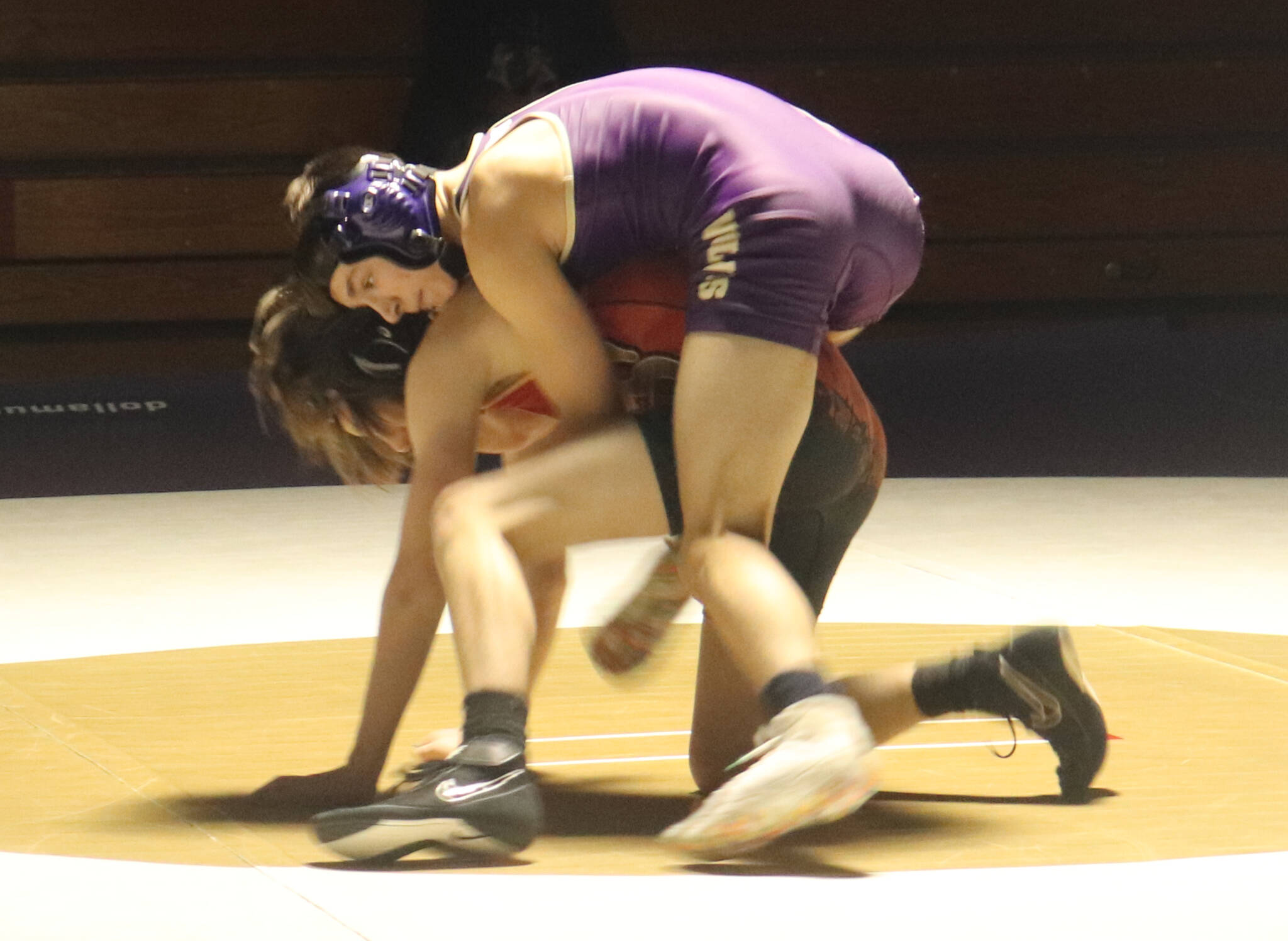 Photo by Roger Burwash / Sequim’s Cayden Beauregard, top, takes on a Kingston wrestler in the 113-pound weight class in the Wolves’ Dec. 14 home league meet.