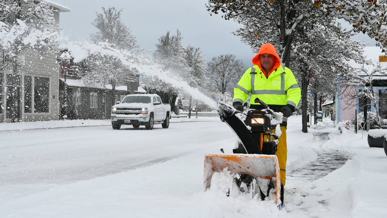 Sequim Gazette photo by Michael Dashiell / City of Sequim staffer Ryan Ross clears snow from the sidewalk on north Sequim Avenue on Dec. 20.