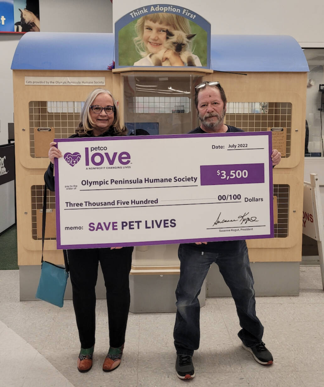 Submitted photo
Luanne Hinkle, Olympic Peninsula Humane Society’s executive director, accepts a $3,500 grant investment from national nonprofit Petco Love from Sequim Petco general manager Steve Dale in November.