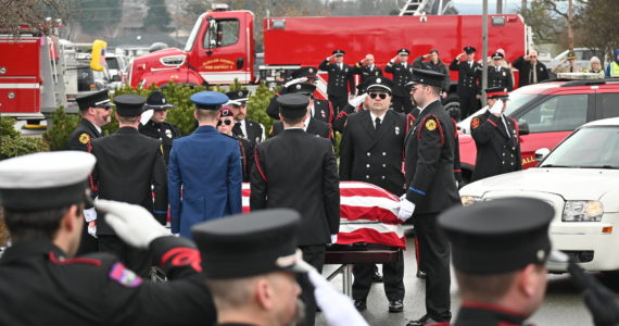 Sequim Gazette photo by Michael Dashiell / Firefighters pay tribute to Capt. Charles “Chad” Cate at a memorial service at Sequim High School on Jan. 21.