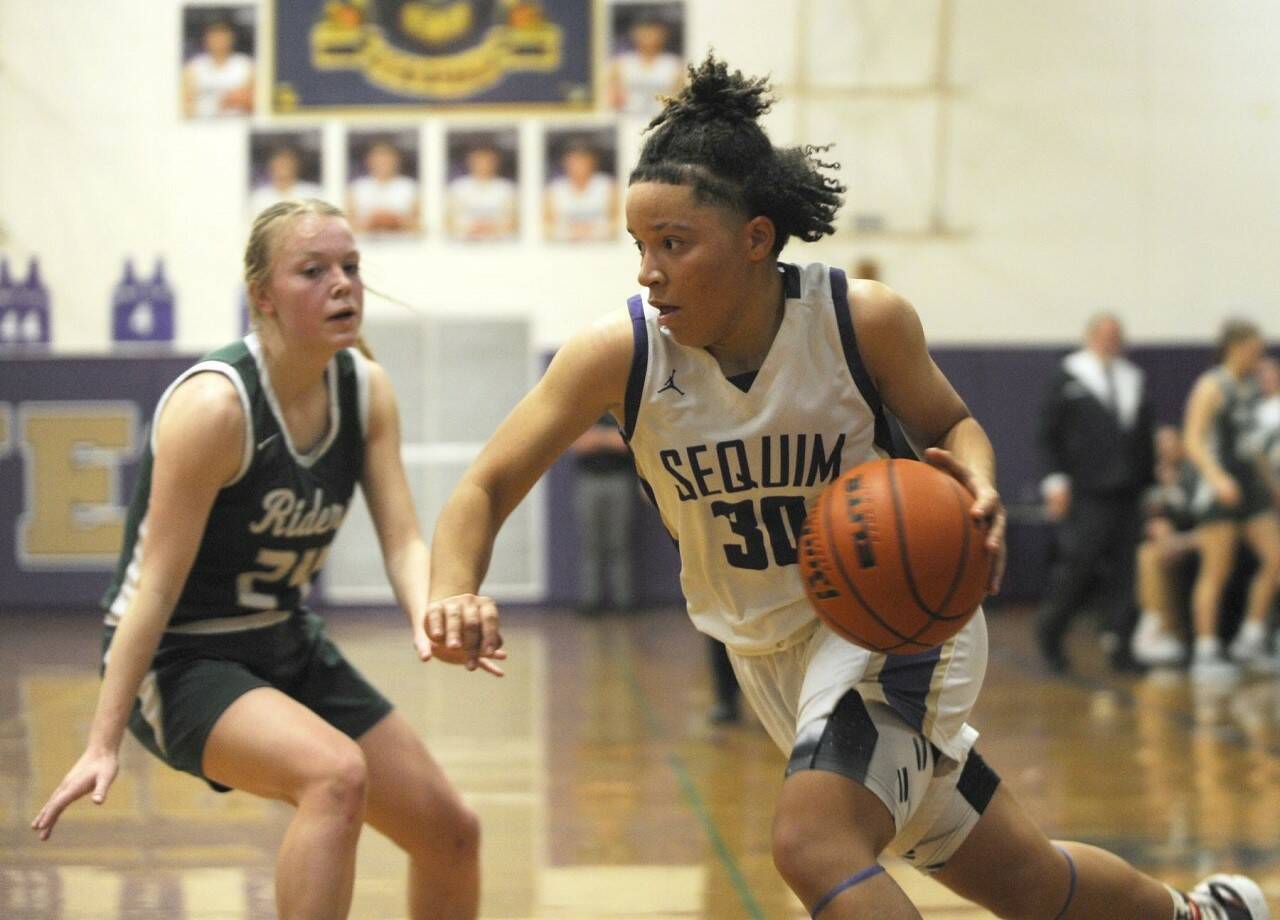 Sequim Gazette photo by Michael Dashiell / Sequim’s Bobbi Mixon drives the ball against Port Angeles’ Anna Petty in a Feb. 2 league game in Sequim. The Wolves won 57-46, thanks to a big third quarter.