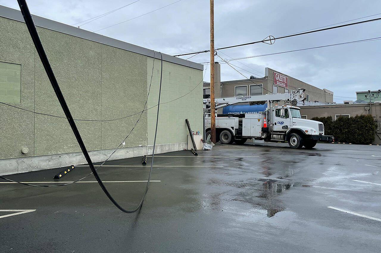 Sequim Gazette photo by Matthew Nash
Clallam PUD crews worked for about 12 hours on Feb. 5 to repair a downed power pole next to the Sequim Gazette building after a man allegedly smashed a stolen vehicle into it and fled.