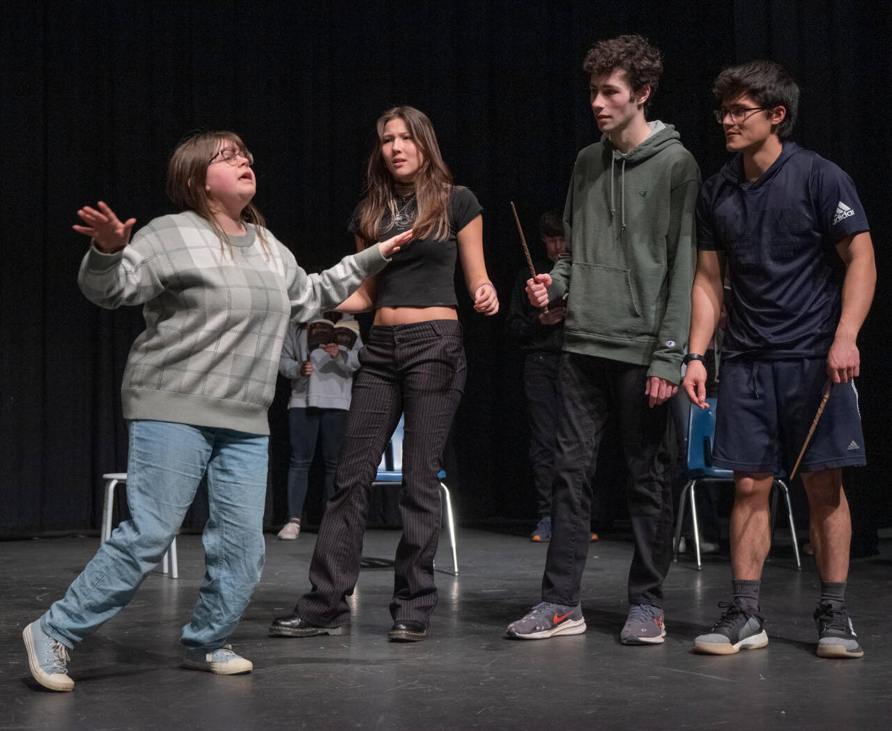 Sequim Gazette photo by Emily Matthiessen / From left to right, Sophia Treece performs a humorous, slow motion fall as Danika Chen, Ayden Humphries and Calem Klinger react, in a recent rehearsal for the upcoming production “Puffs,” at the High School auditorium.