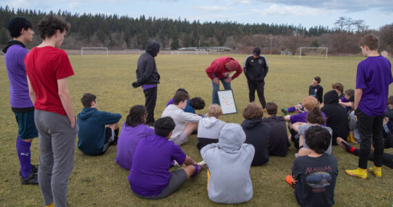 Sequim Gazette photo by Emily Matthiessen / From left, junior varsity coach Dave Breckenridge, and assistant coaches Jared King and Javier Gomez lay out a practice plan for the junior varsity soccer team.