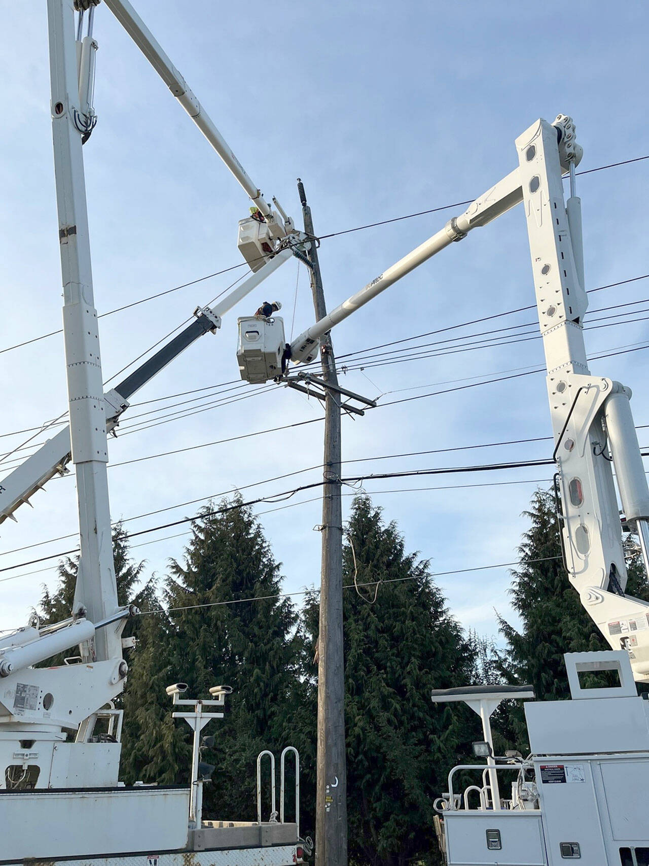 Photo courtesy of Clallam County PUD / Crews from Clallam County Public Utility District work to restore power last week. About 1,300 Clallam County PUD customers lost power at 2:30 a.m. on March 30 after a car hit a pole at Elizabeth Lane and Old Olympic Highway.