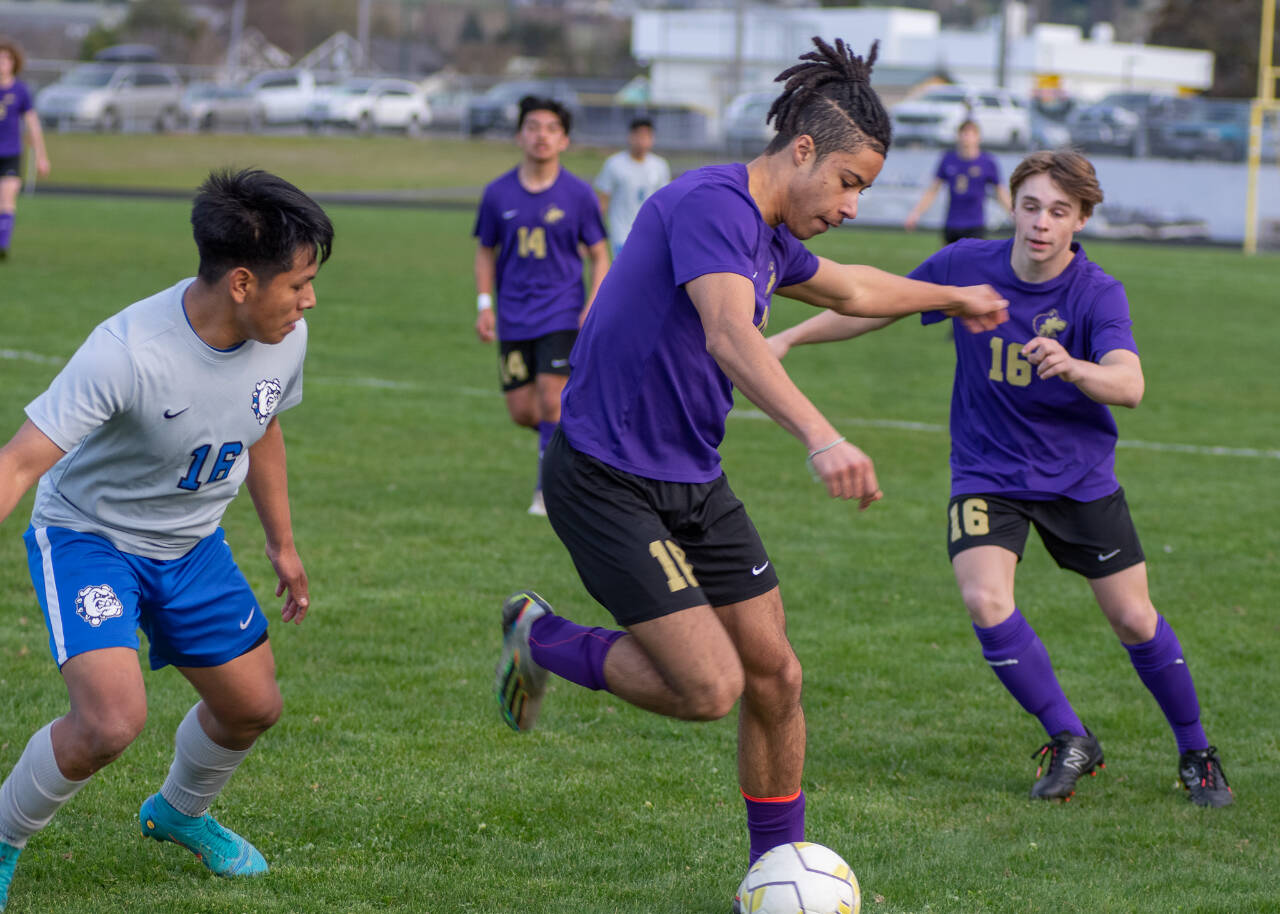 Sequim Gazette photo by Emily Matthiessen
Sequim’s Mekhi Ashby, center, gains control as teammates Evan Cisneros (14) and James Mason (16) and North Mason’s Alex Pablo Pablo look on. Sequim topped the visiting Bulldogs 2-1 on April 13.