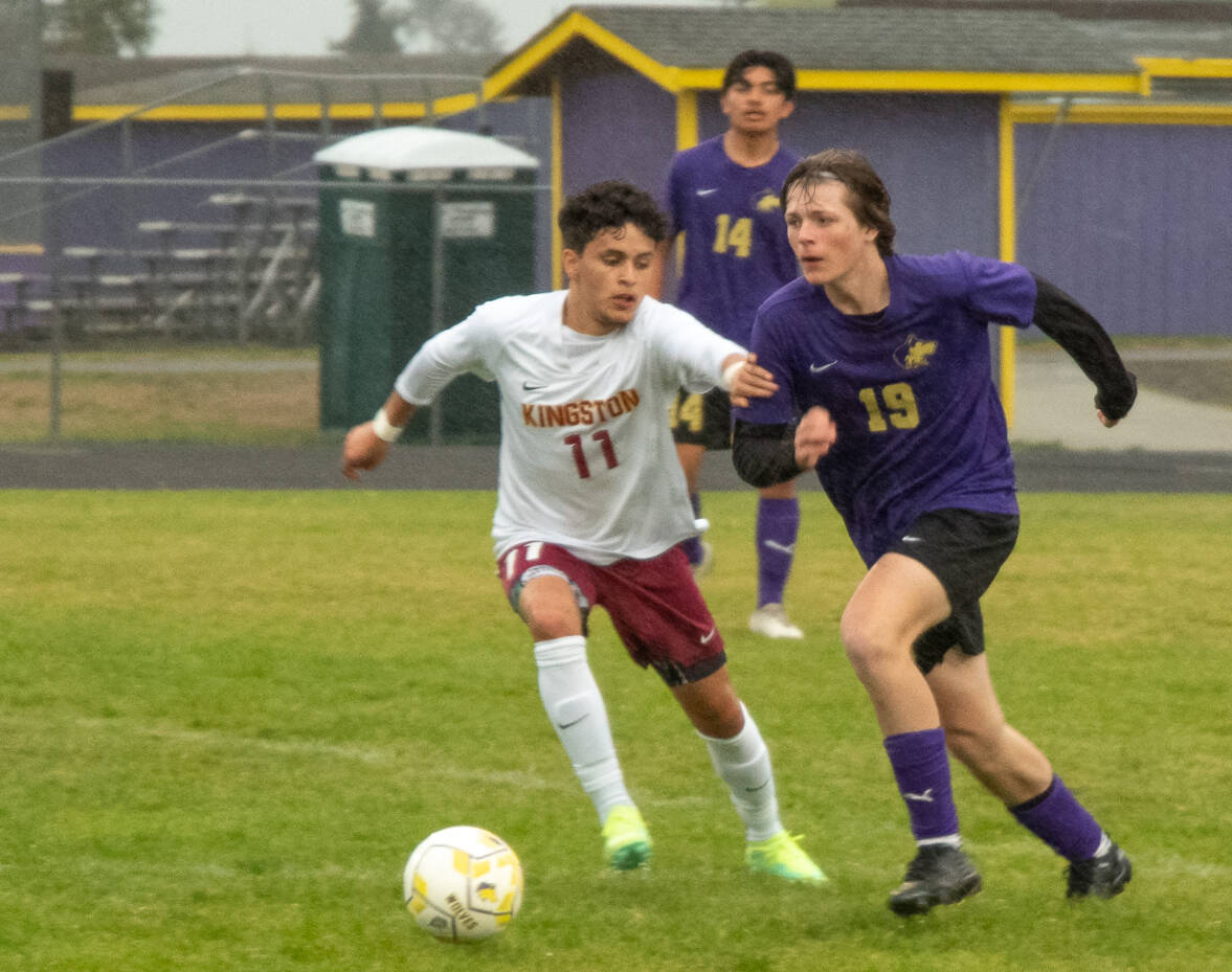 Sequim Gazette photo by Emily Matthiessen / Sequim’s Finn Braaten, right, advances the ball toward Kingston territory as Buccaneer Anthony Haroz gives chase. Kingston won the May 4 league match-up 2-1 in extra time.