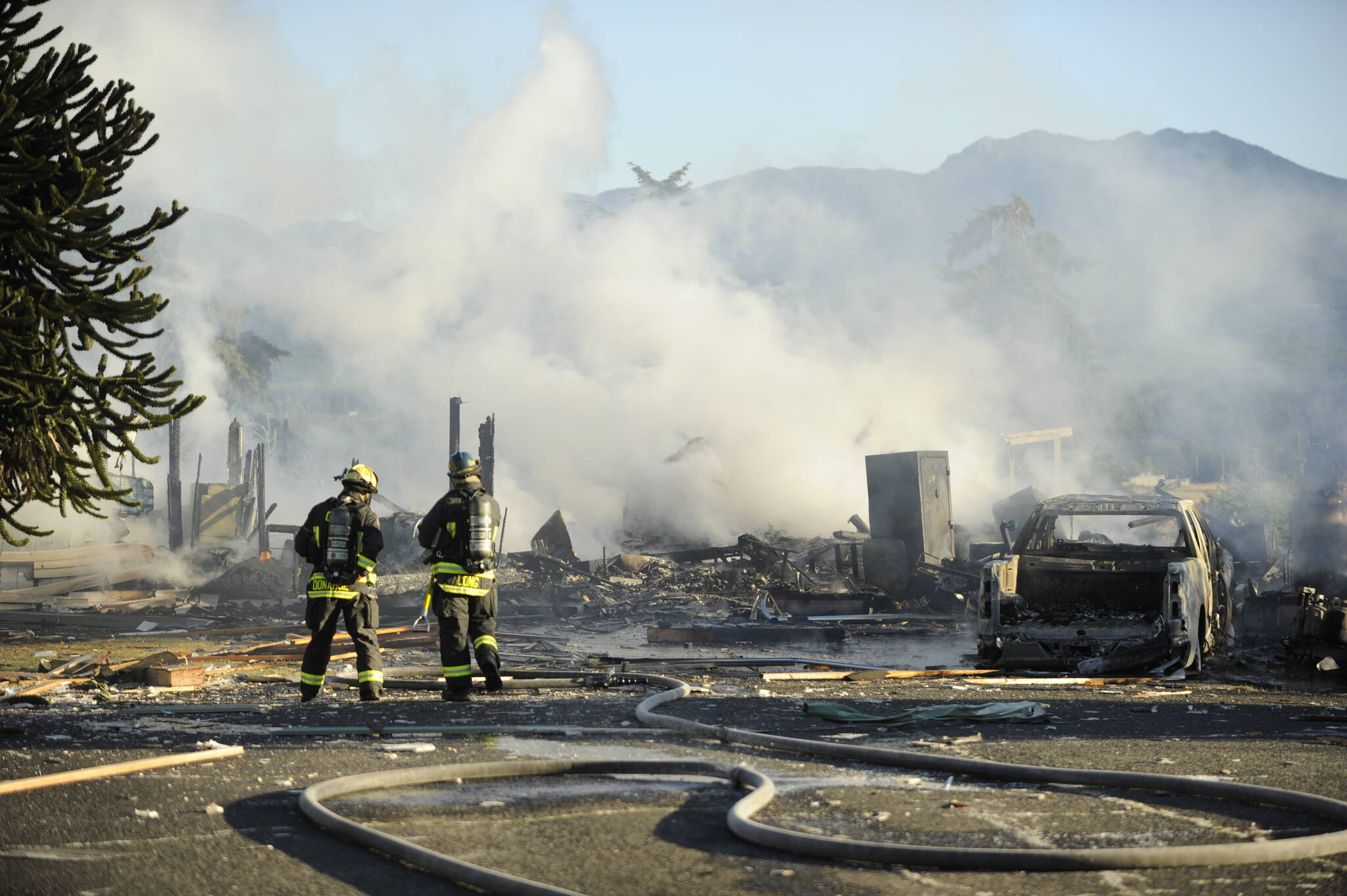 Sequim Gazette photo by Michael Dashiell
Firefighters with Clallam County Fire District 3 respond to a home explosion and fire on the 100 block of June Place on July 18. Law enforcement officials ruled the explosion accidental.