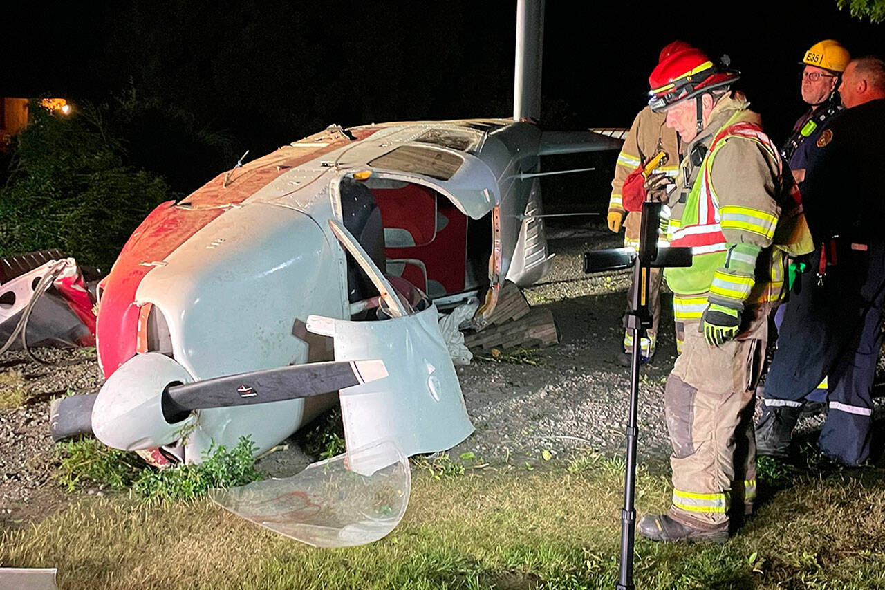 Sequim Gazette photo by Matthew Nash/ Firefighters with Clallam County Fire District 3 investigate a plane crash in Agnew on July 29. Its pilot was transported to Olympic Medical Center, and later treated and released. The passenger was flown to Harborview Medical Center in Seattle and remains in satisfactory condition as of Monday afternoon.