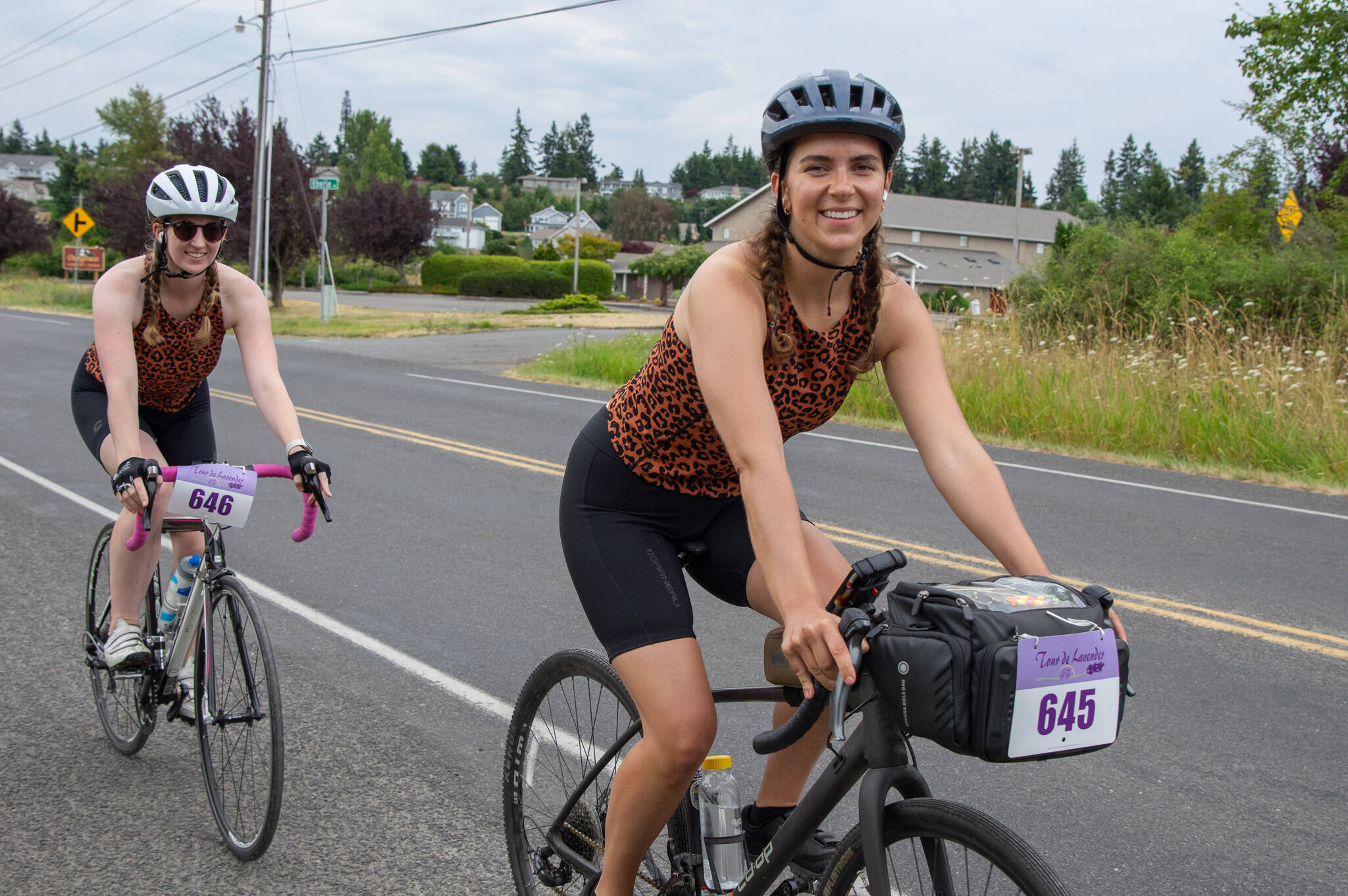 Sequim Gazette Photo by Emily Matthiessen
Friends Elisse Tolley and Stephanie Bailey (front) of Seattle rode together in the 64-plus mile Tour de Lavender Metric Century last Saturday. The friends said that the ride was beautiful, car drivers were courteous and the volunteers and other locals were kind.