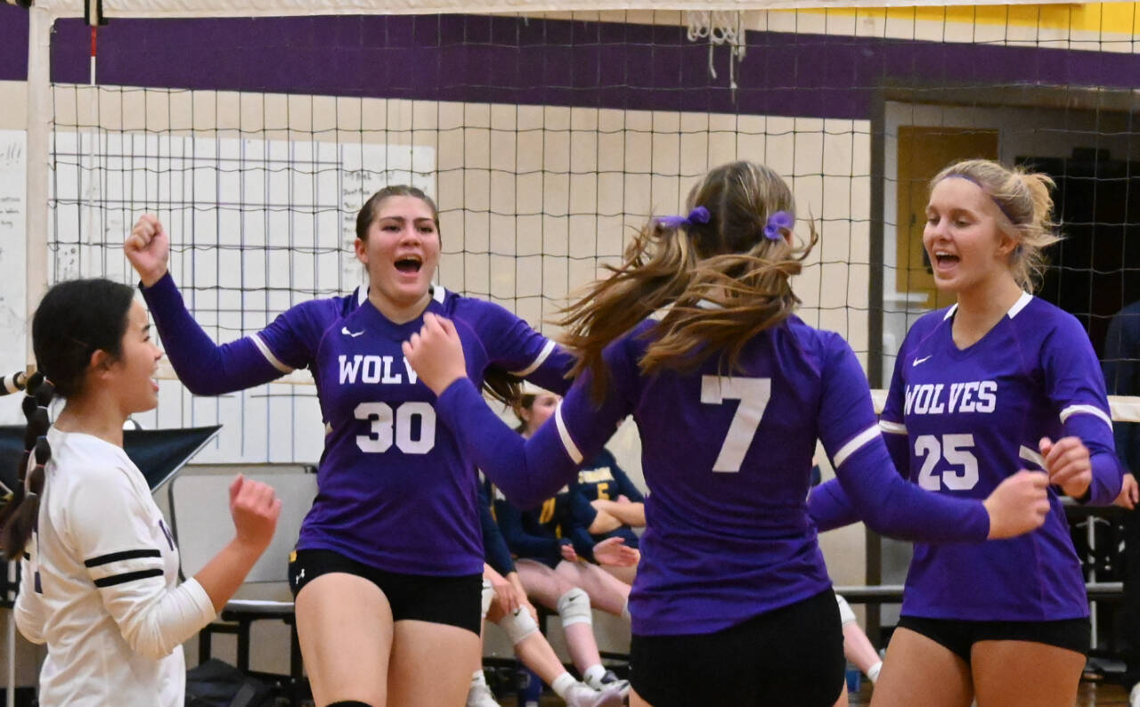 Sequim Gazette photo by Michael Dashiell
Sequim players (from left) Tiffany Lam, Brianna Palenik, Sydney Clark and Jolene Vaara celebrate a point near the end of the third game in a home match against 3A Bainbridge on Sept. 26.