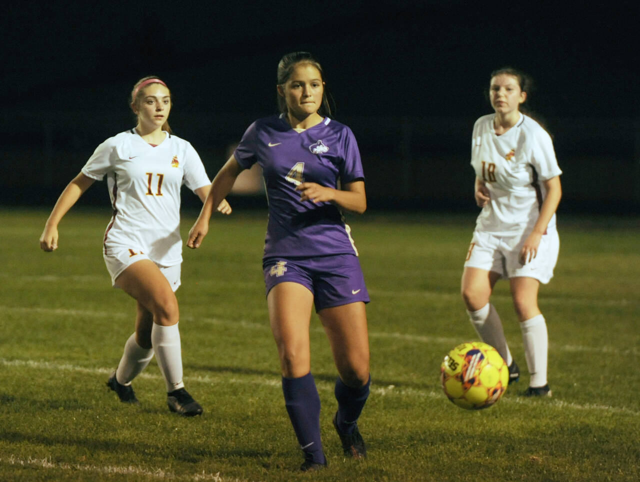 Sequim Gazette photo by Michael Dashiell
Sequim’s Raimey Brewer, center, passes to a teammate in the second half of the Wolves’ 4-0 home win over Kingston on Oct. 3. Looking on is Kingston’s Savannah Lennette (11) and Katie Zehrung (18).