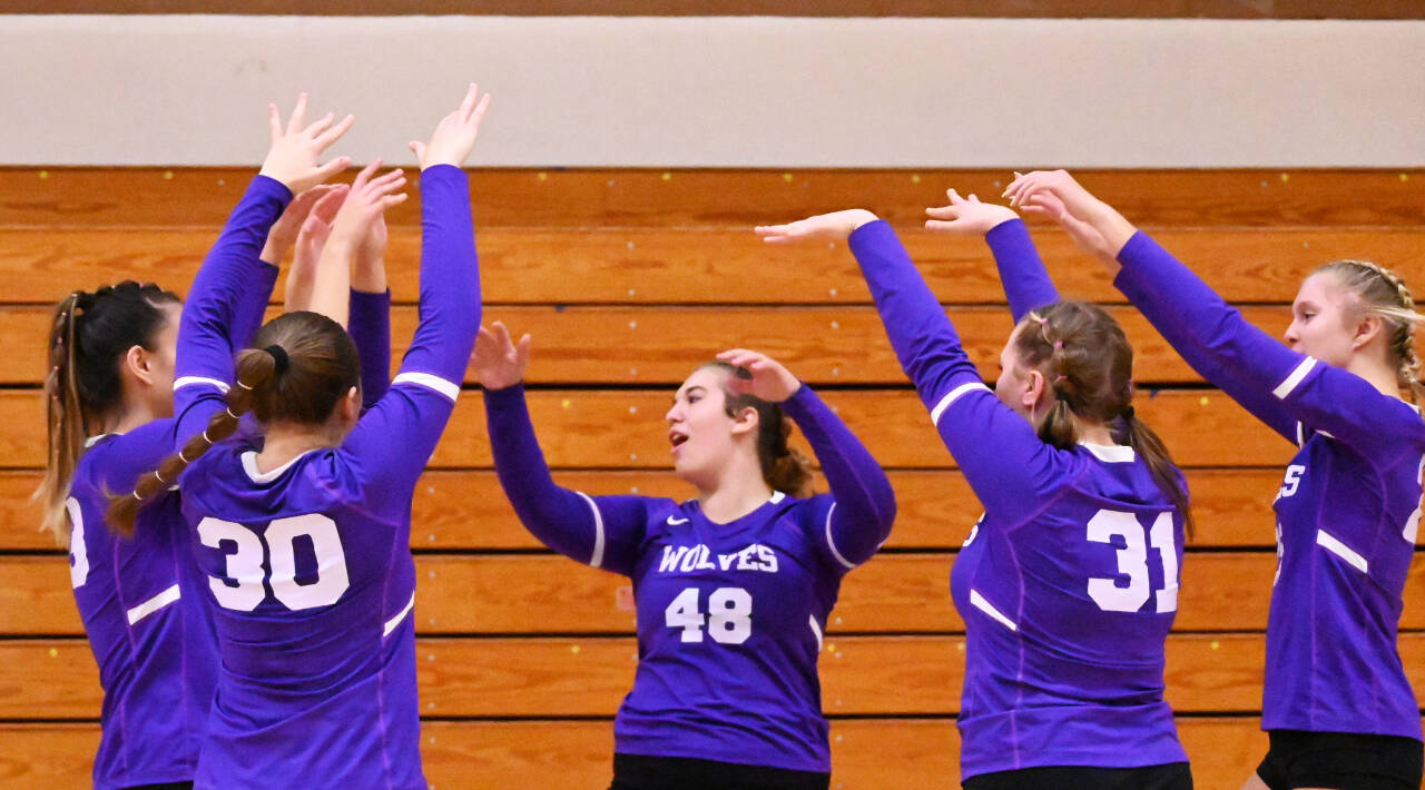 Sequim Gazette photo by Michael Dashiell / Sequim’s Sydney Hegvedt (48) and teammates celebrate a big block in a three-set sweep of Bremerton on Oct. 24.