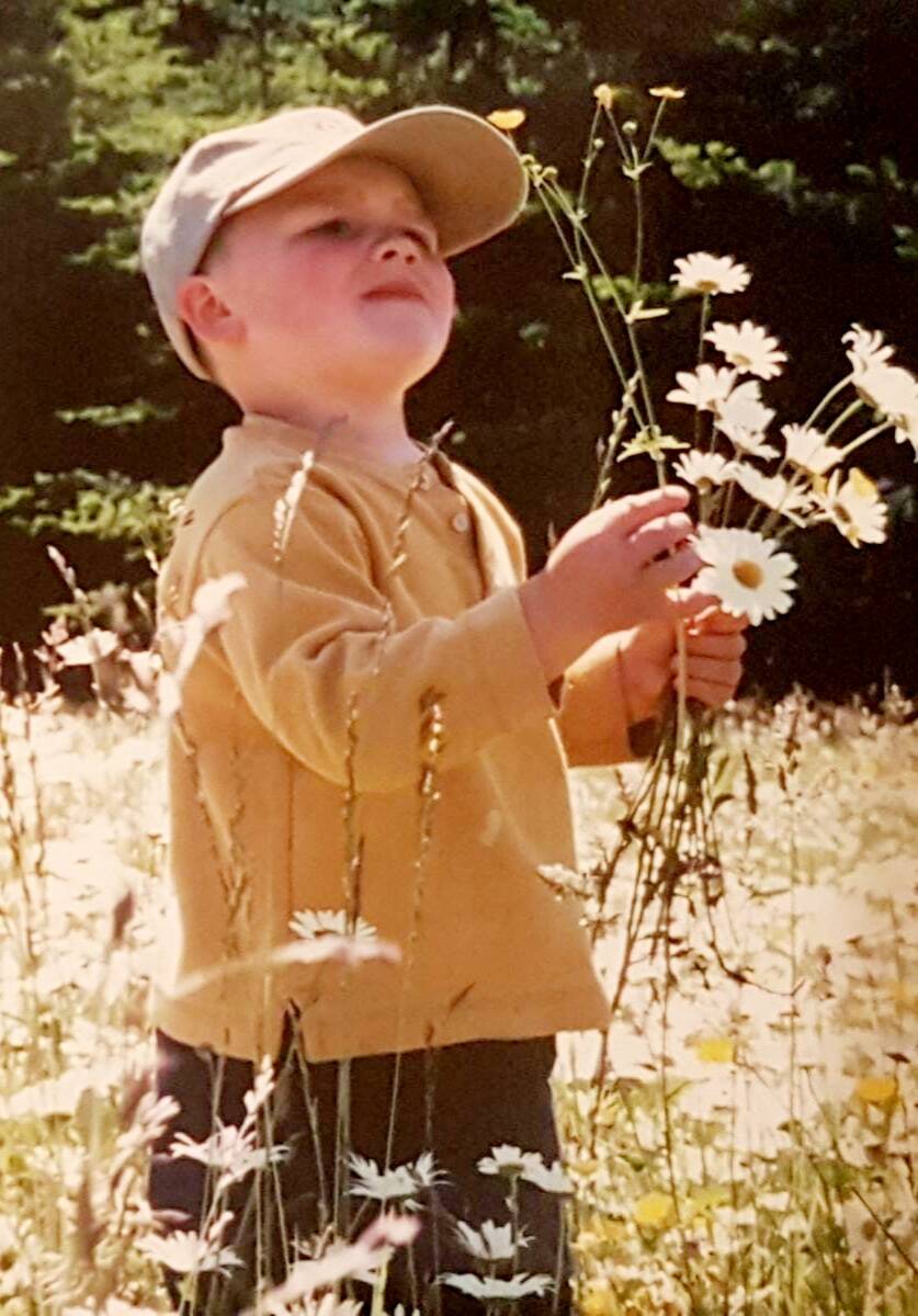 Photo courtesy of Teresa Smith
Isaac Smith, pictured here picking flowers in a family photo, loved nature and in particular eagles and all sorts of birds found across Sequim, his mother Teresa Smith said. She helped fundraise for sets of binoculars now available at the Dungeness River Nature Center that pay tribute to her son.