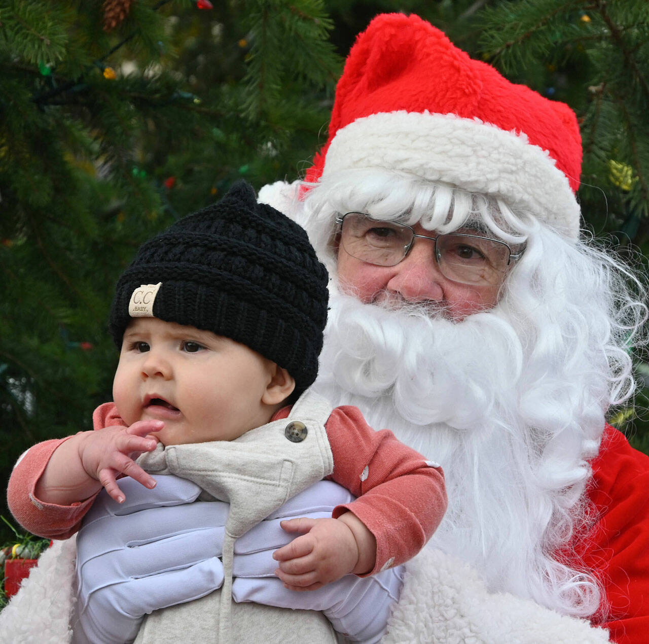 Sequim Gazette file photo by Michael Dashiell / Maisy Gonzalez spends some quality time with Santa Claus (Stephen Rosales) at the Hometown Holidays event in 2022. It returns from 1-5 p.m. Nov. 25 with photo-ops with Santa going from 2-4 p.m.