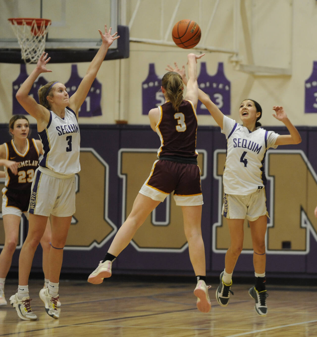 Sequim Gazette photo by Michael Dashiell / Sequim’s Jolene Vaara (3) and Gracie Chartraw (4) defend the basket at Enumclaw’s Kalee Swanson (3) passes to teammate Ava Smith in a bi-district tournament game on Feb. 14 in Sequim. Enumclaw’s Hornets won, 66-49.