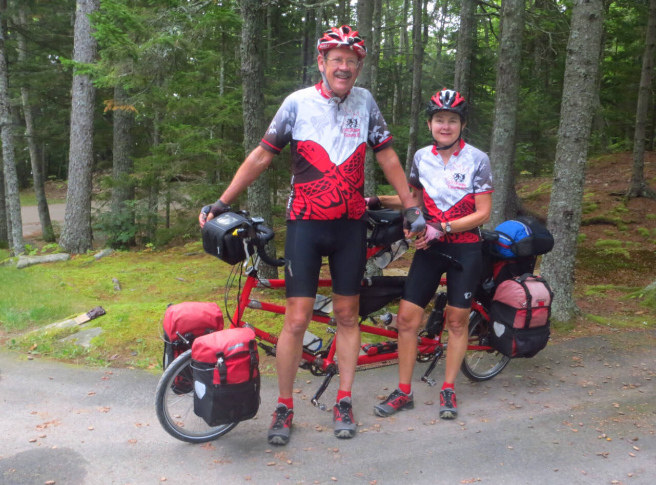 Photo courtesy of Jeff and Louise Davis
Jeff and Louise Davis are pictured with “Little Red,” two-wheeled transportation for their canoeing adventure.