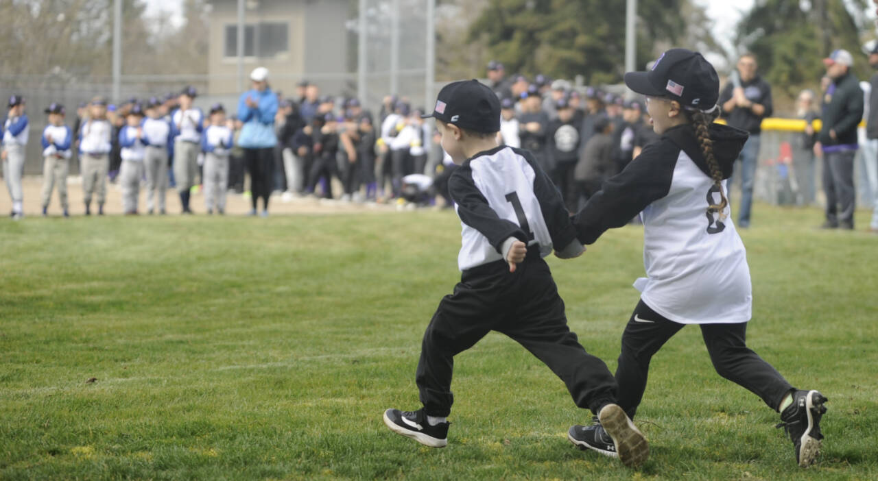 Sequim Gazette file photo by Michael Dashiell / A pair of young ballplayers race onto the field at the Sequim Little League Opening Day ceremony in 2023. This year’s festivities kick off at 10 a.m. on Saturday, April 13, at James Standard Park,124 W. Silberhorn Road.