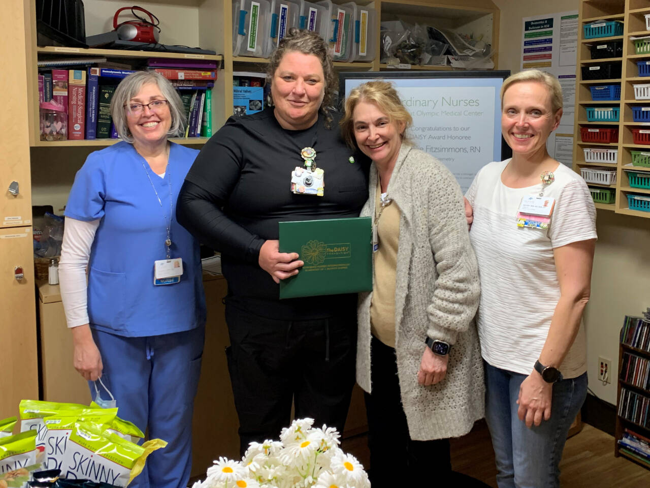 Photo courtesy of Olympic Medical Center / Brooke Fitzsimmons, second from left, accepts her DAISY Award for Extraordinary Nurses from colleagues. Pictured with Fitzsimmons are, from left, ICU/telemetry supervisor Janeen Howell, Chief Nursing Officer Vickie Swanson and ICU/telemetry director Katrin Junghanns-Royack.