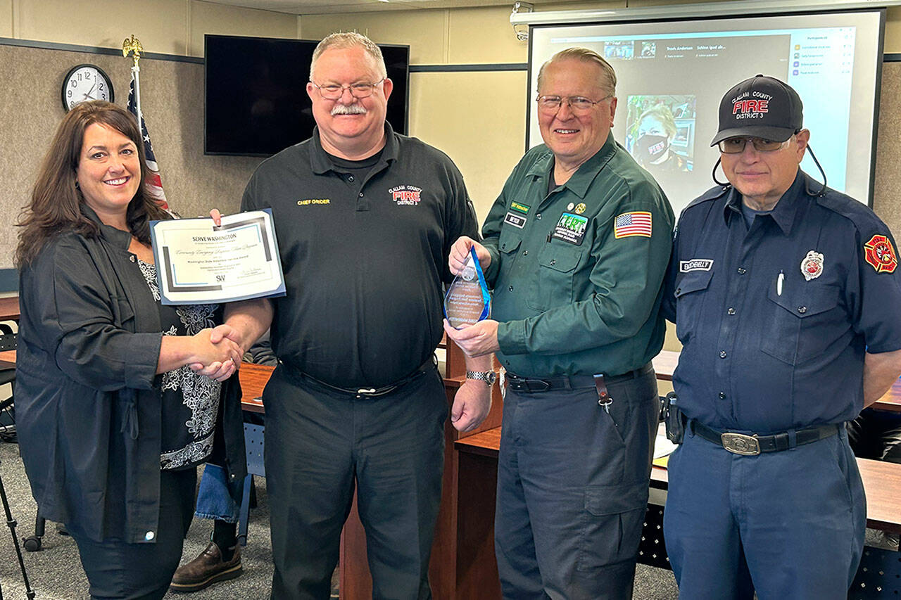 Sequim Gazette photo by Matthew Nash
The Sequim area’s Community Emergency Response Team (CERT) program received the volunteer service award for its efforts last year. Presenting the award on April 16, was Diane Klontz, deputy director for Division and Program Alignment with the Washington State Department of Commerce, to, from second left, Clallam County Fire District 3 Fire Chief Justin Grider, Charles Meyer, a CERT division chief, who nominated the program for the award, and CERT Senior Program Manager Blaine Zechenelly.