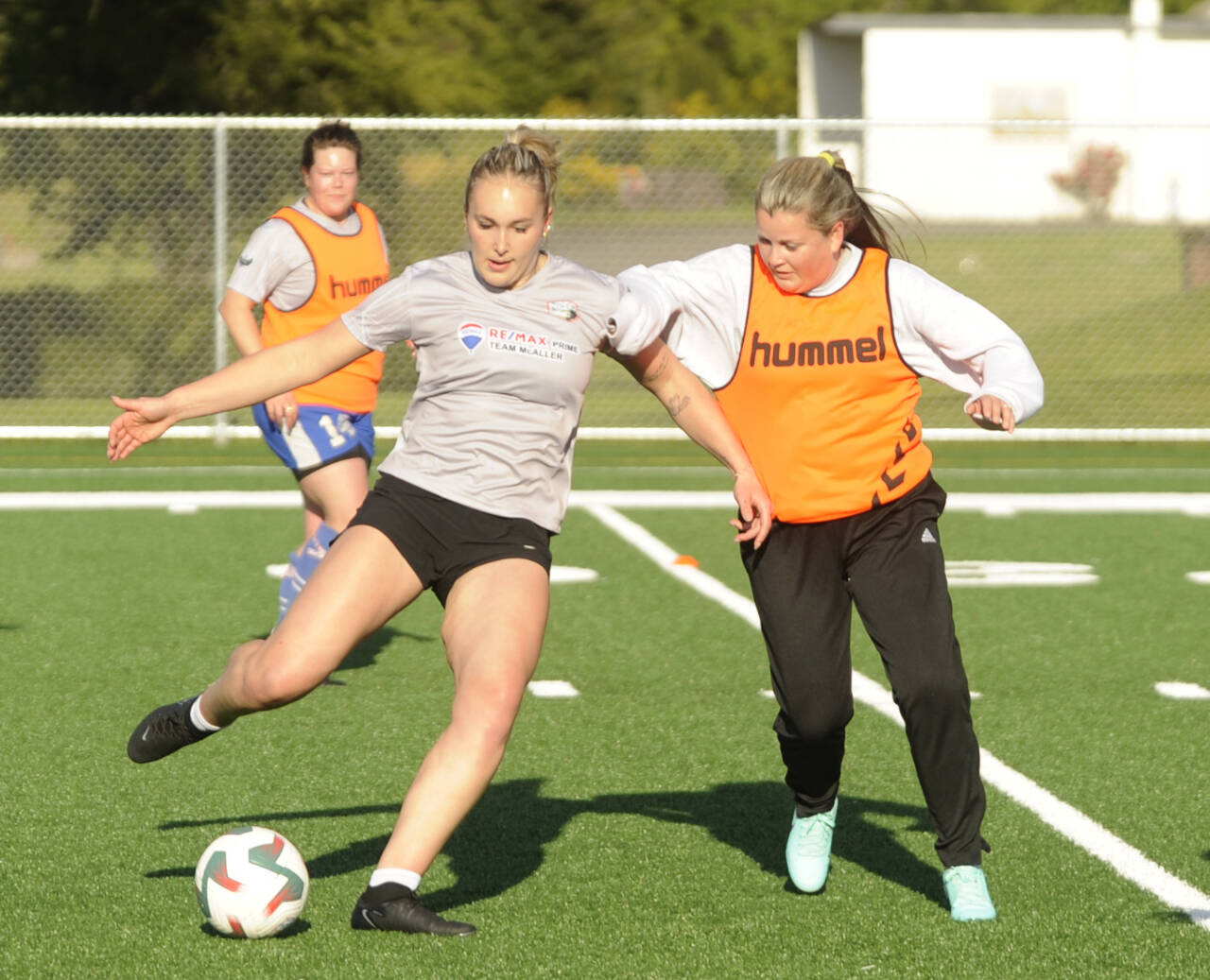 Sequim Gazette photo by Michael Dashiell / Sequim High grad Olivia Hare, left, vies for possession with teammate Lisa Hansen in a scrimmage at a North Peninsula Football Club practice in Port Angeles on May 7.