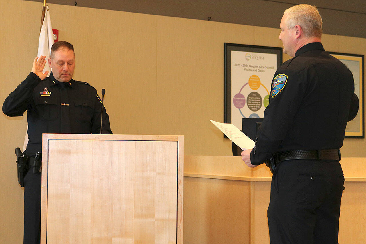 Photo courtesy City of Sequim/ New Sequim Police Deputy Chief John Southard is sworn in on May 1 by Police Chief Mike Hill in the Sequim City Council chambers.