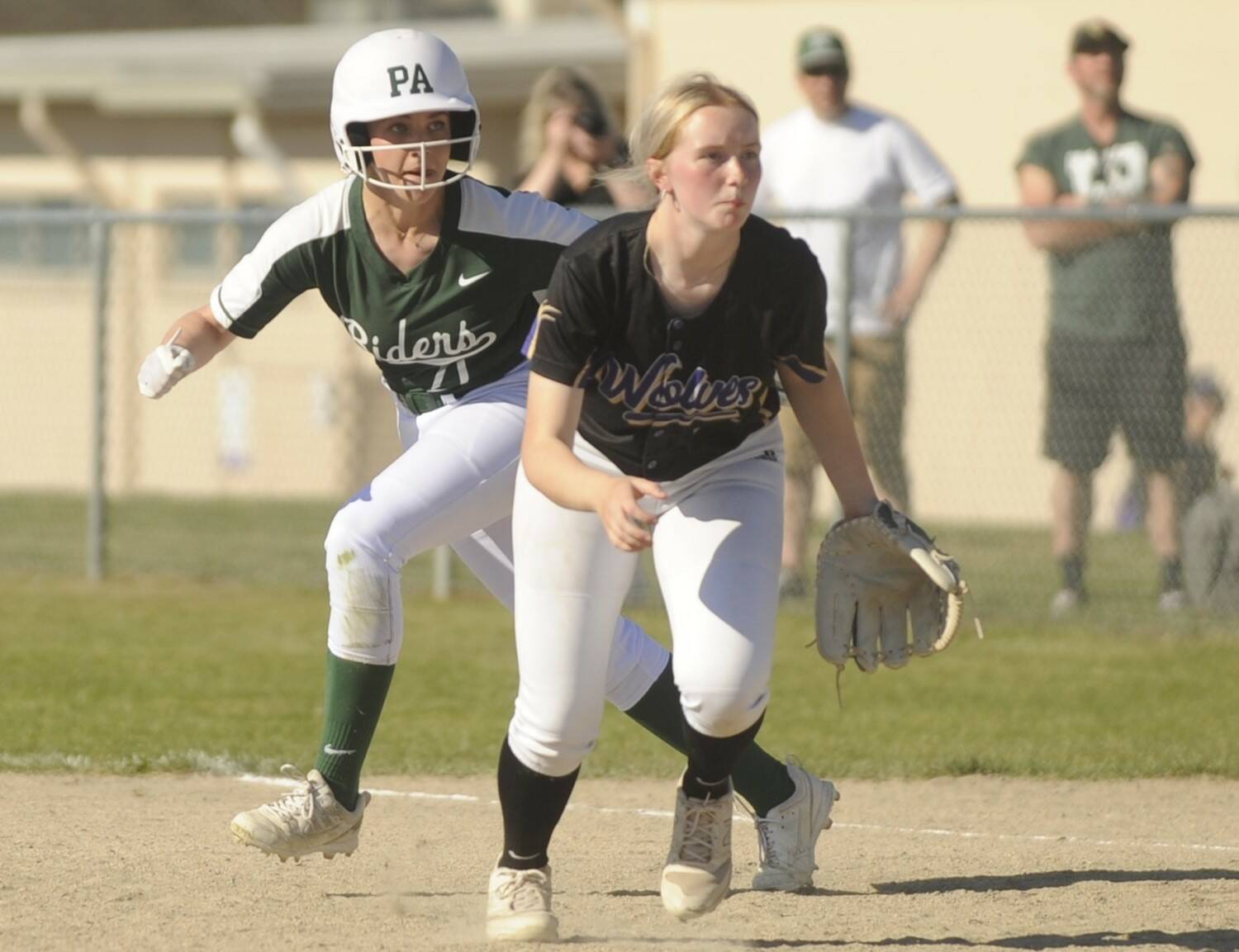 Sequim Gazette photo by Michael Dashiell / Port Angeles’ Ava-Anne Sheahan takes a lead off first base behind Sequim first baseman Ava Ritter on May 10.