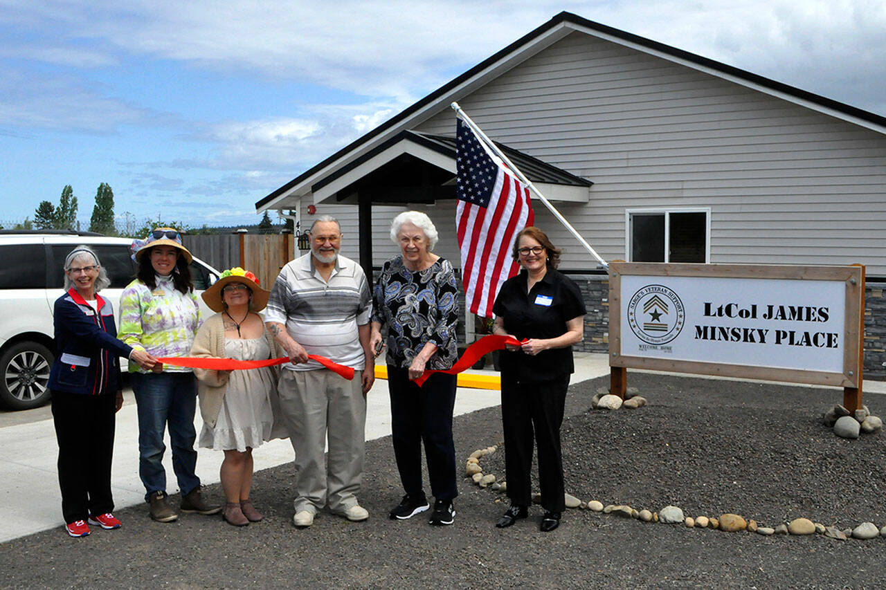 Sequim Gazette photos by Matthew Nash
Helen and Greg Starr, executors of James Minsky’s estate, cut the ribbon for LtCol James Minsky Place on May 17 with Cheri Tinker, executive director of Sarge’s Veteran Support, on right, and Sarge’s board president Lorri Gilchrist, and city councilors Harmony Rutter and Rachel Anderson. The facility will permanently house six disabled and/or elderly veterans in Sequim.