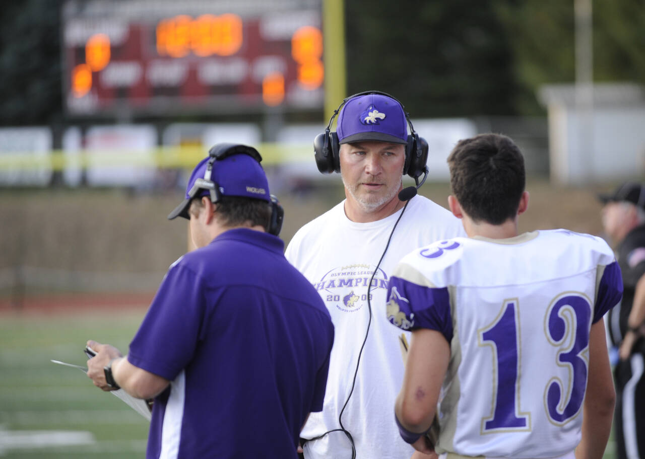 Sequim Gazette file photo by Michael Dashiell / Sequim head coach Erik Wiker talks with son Taig, then a sophomore, in a game at Montesano in 2017. Wiker coached four of his sons in the football program.