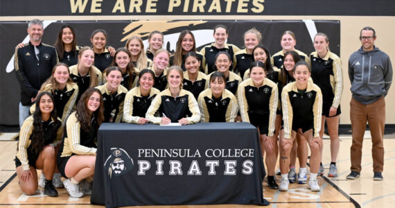 Peninsula College's Hannah Wagner of Sequim signs to play soccer for Vancouver Island University surrounded by her teammates and assistant coach Andrew Cooper and head coach Kanyon Anderson. Wagner was also the women's soccer team recipient of the Wally Sigmar and Art Feiro awards for leadership, academics and citizenship.  (Peninsula College)