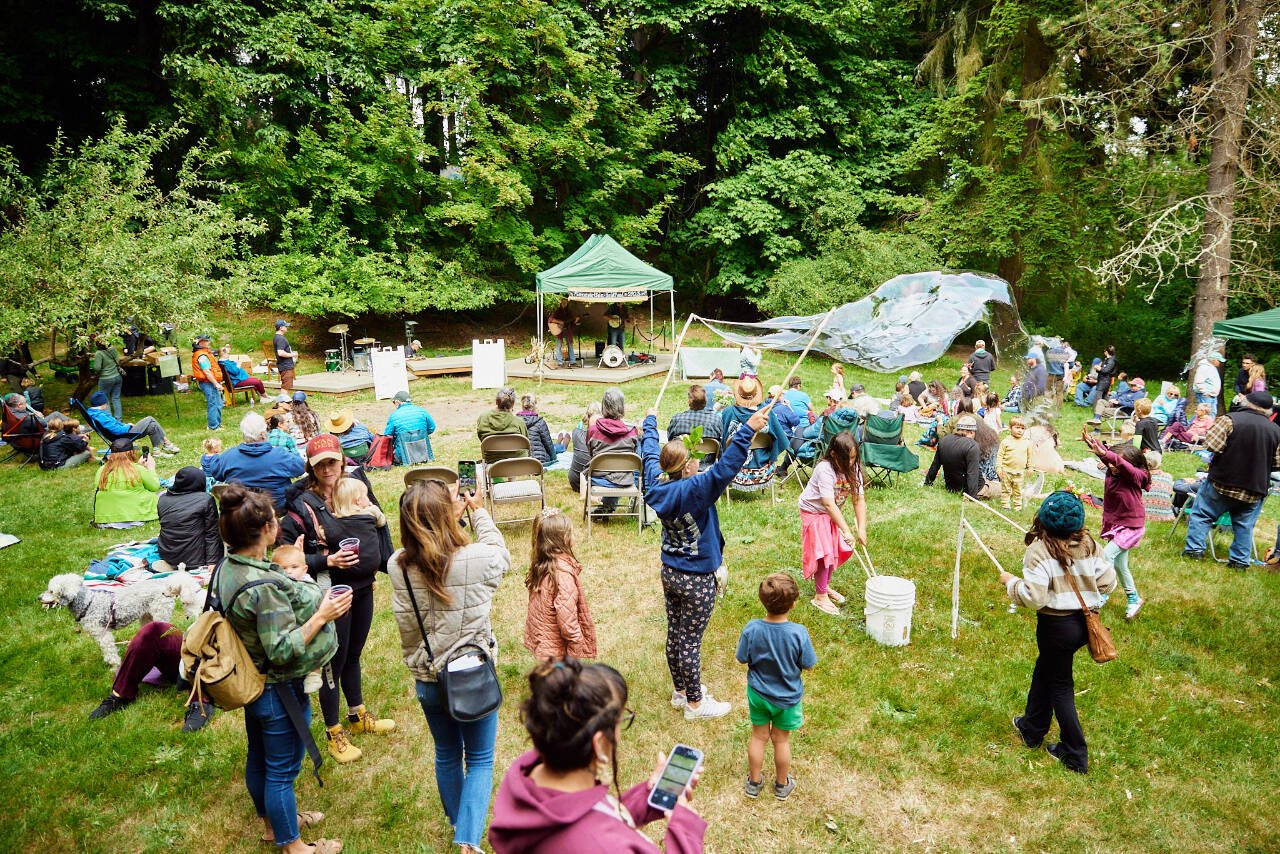 Photo by CasCadia Films
A crowd enjoys the Summertide Festival in the meadow of Webster’s Woods in 2023.