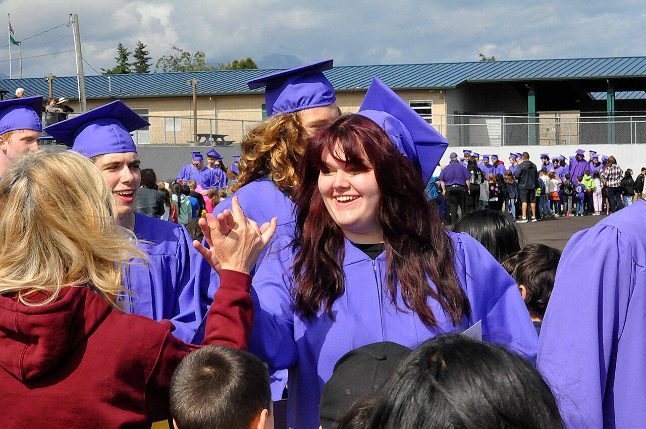 Sequim Gazette photos by Matthew Nash
Sequim High senior Addison Frisby high-fives teacher Caryn Little while participating in the SHS Grad Walk on June 14.