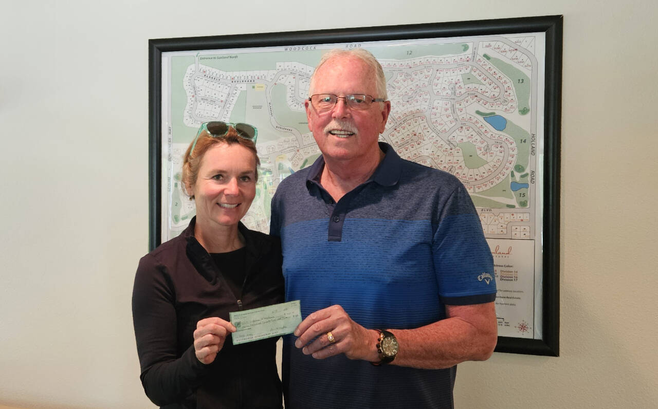 Photo courtesy of Sequim Sunrise Rotary
Eric Mahnerd of Sequim Sunrise Rotary presents a $750 donation to Nicole Lepping, founder of the Sequim Wheelers, to help replace her organization’s equipment.