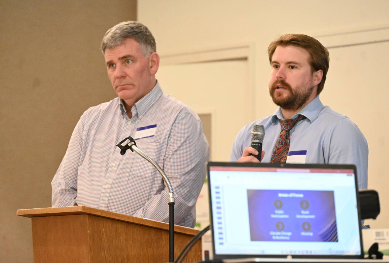 Sequim Gazette photo by Michael Dashiell / At left, Bruce Emery, director of Community Development for Clallam County, and Holden Fleming, the department’s chief deputy director, talk about the county’s Agriculture Accessory Use ordinance with members and other attendees of the Sequim-Dungeness Valley Chamber of Commerce’s luncheon in Sequim on June 25.