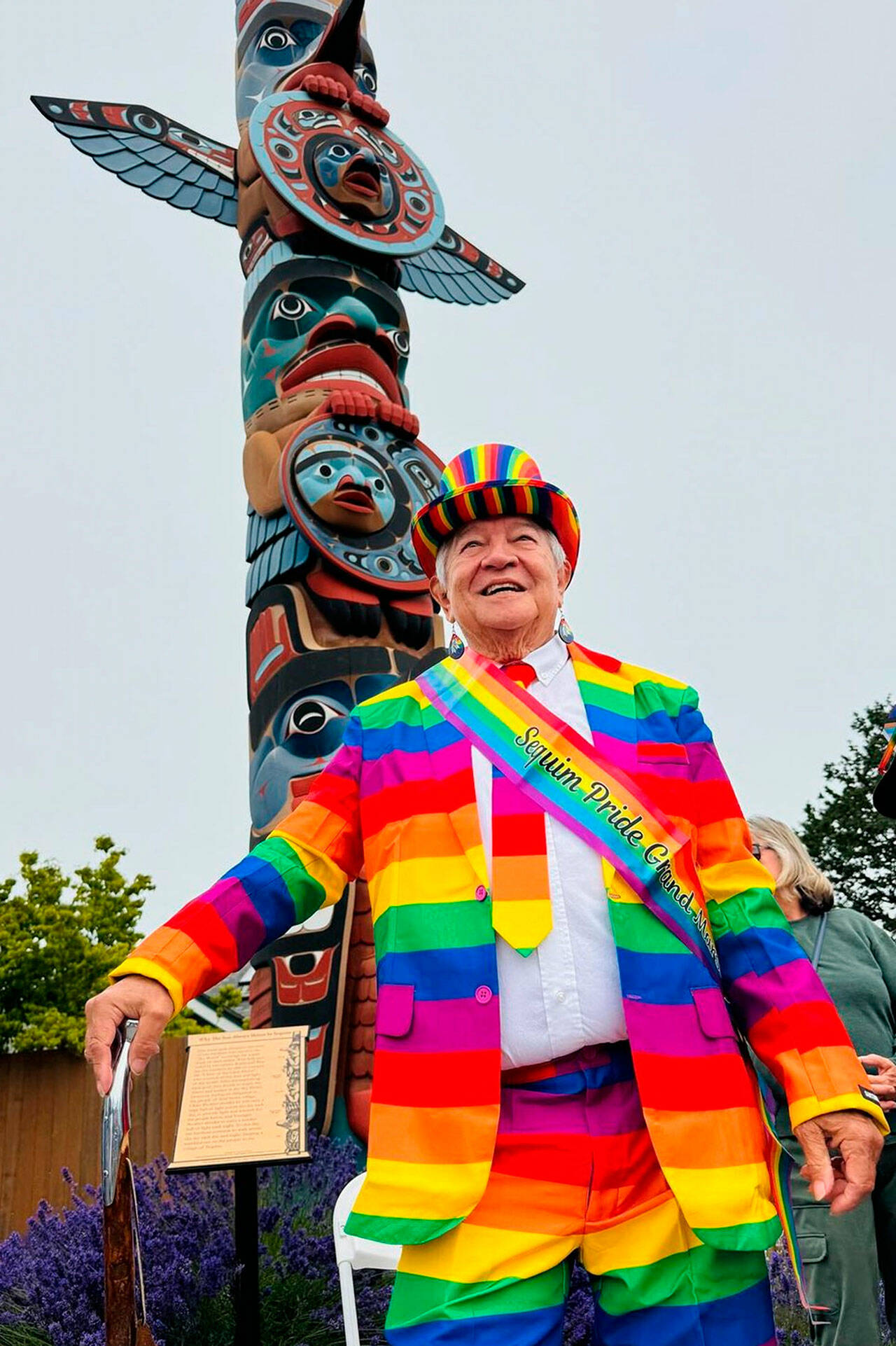 Photo courtesy David Owen Hastings
Michael Lowe, grand marshal of Sequim Pride, stands by the totem pole during the event on June 29 in downtown Sequim.