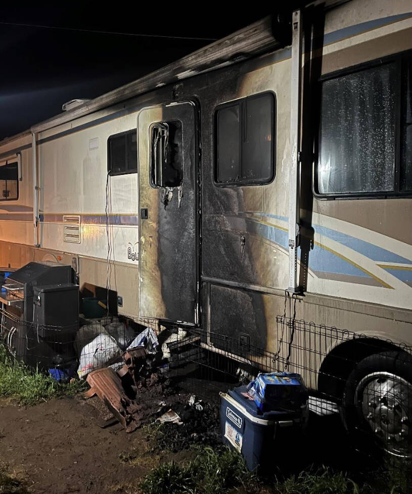 Photo courtesy of Clallam County Fire District 3 / An early-morning fire on July 3 sent a Sequim man to the hospital with second degree burns. Firefighters say the likely cause was discarded cigarette ash that burned a pile of cardboard and trash just outside a recreational vehicle.