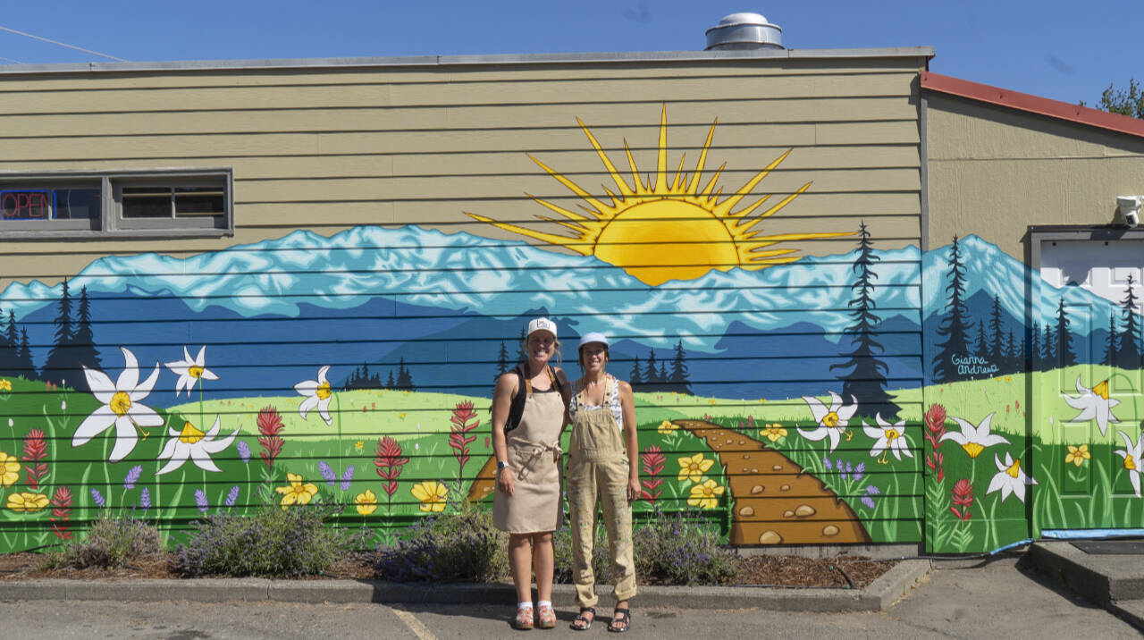 Photo courtesy of Uptown Arts District
Emily Little, left, owner of Buena Luz Bakery in Port Angeles, joins artist Gianna Andrews in front of a new mural in the Uptown Arts District in Port Angeles. A Mural Launch Party is set for July 27.