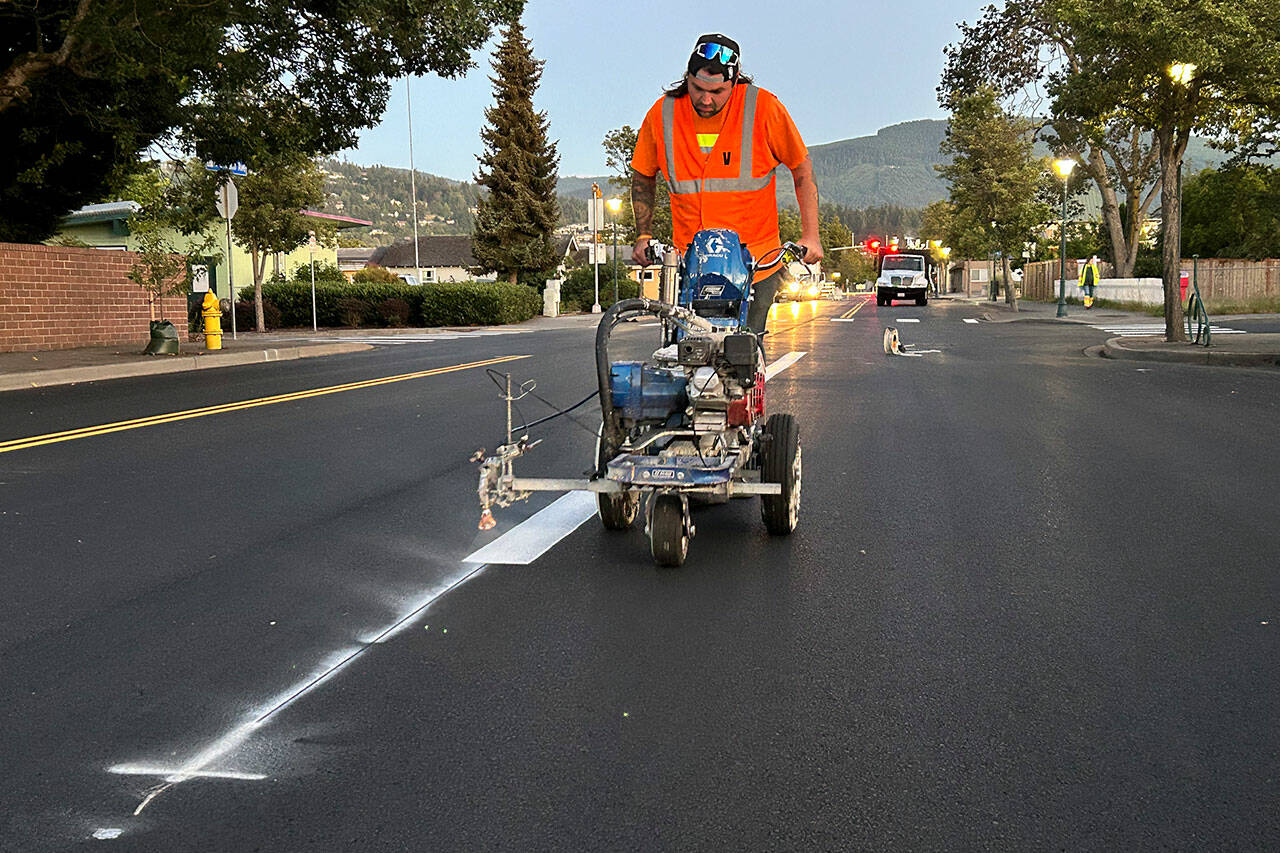 Sequim Gazette photo by Matthew Nash
David Scott with Stripe Rite out of Bremerton paints lines on July 1 along Sequim Avenue as part of an overlay project through the City of Sequim and led by Lakeside Industries.