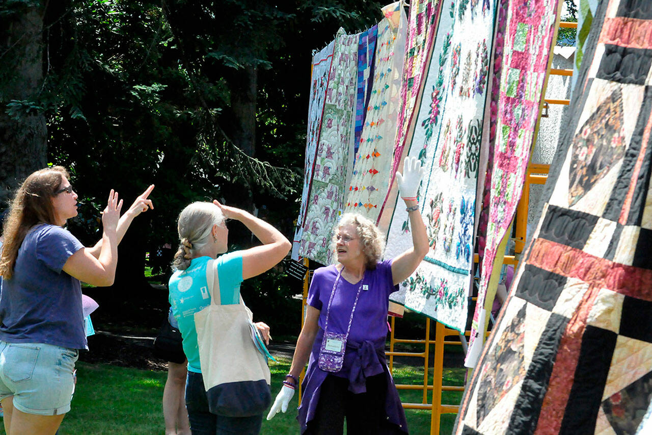 Sequim Gazette photo by Matthew Nash
Bernadette Shein helps answer quilt questions for visitors of the Sunbonnet Sue Quilt Club’s annual quilt show in 2023. This year, the event moves to Trinity United Methodist Church and expands to two days, July 19-20.