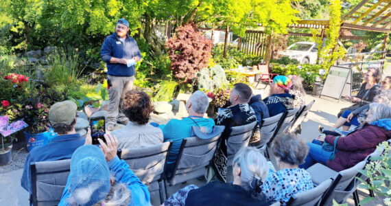 Stew Cockburn, from New Dungeness Nursery in Sequim chats with guests during an event at the nursery. New Dungeness Nursery photo