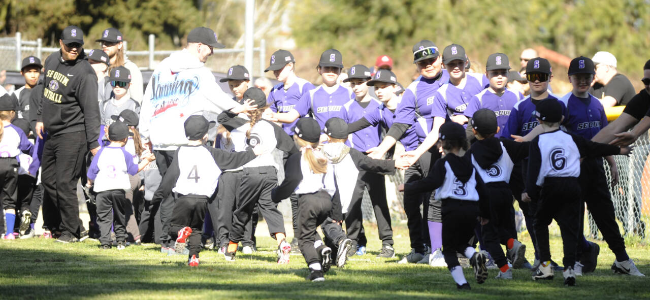 Sequim Gazette file photo by Michael Dashiell / Players of varying ages give and receive high-fives at Sequim Little League’s Opening Day on April 13. The league is seeking volunteers to fill a number of open positions for the 2025 season.