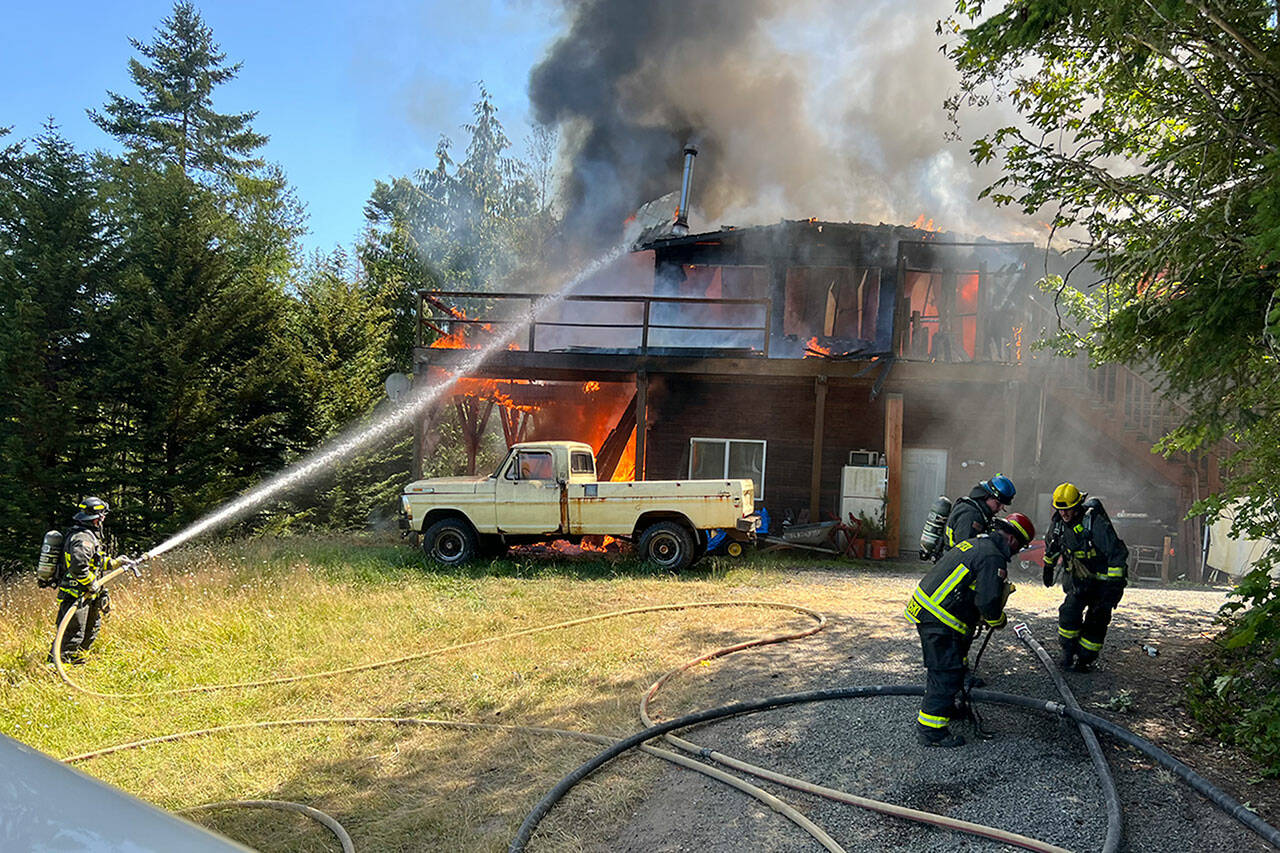 Photo by Paul Lang, CCFD3
A house is deemed a total loss after a fire erupted on July 10 off Palo Alto Road. Firefighters with Clallam County Fire District 3 and Department of Natural Resources fought the house fire and a brush fire.