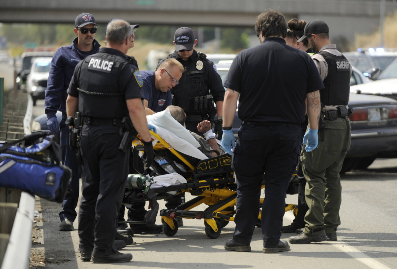 Sequim Gazette photo by Michael Dashiell 
Local law enforcement take into custody a man who reportedly led a high speed chase from Port Angeles to Sequim along U.S. Highway 101 on July 17. The susp[ect was later identified at Steven Michael Huseman.