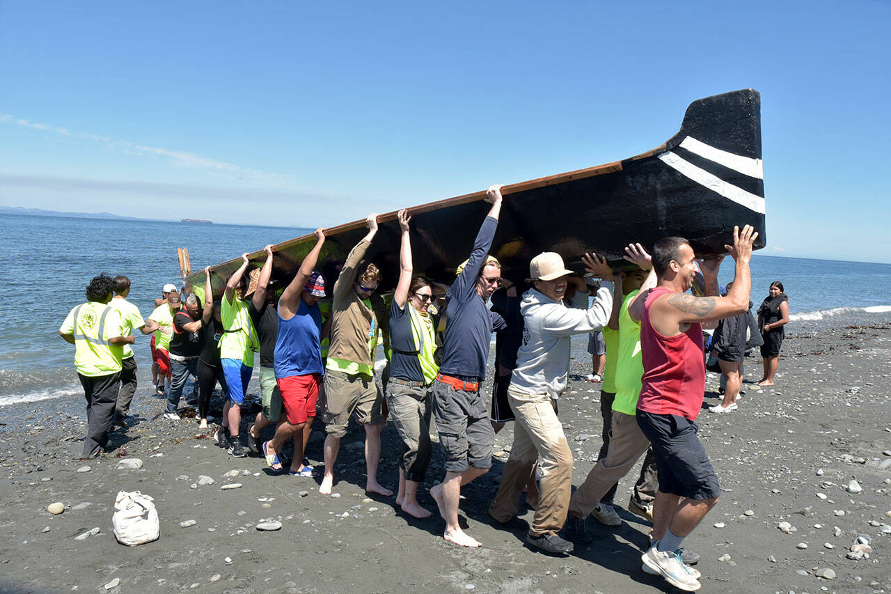 Photo by Keith Thorpe/Olympic Peninsula News Group
A canoe from Ahousaht First nations of western Vancouver Island is hauled ashore by volunteers on Tuesday, July 23, on Lower Elwha Clalllam land near the mouth of the Elwha River west of Port Angeles.