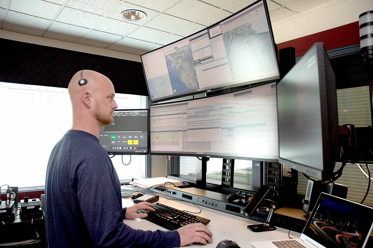 Keith Thorpe/Olympic Peninsula News Group
Communications officer Ian Harrington oversees a bank of computer screens at the Peninsula Communications emergency dispatch center in Port Angeles on July 24.