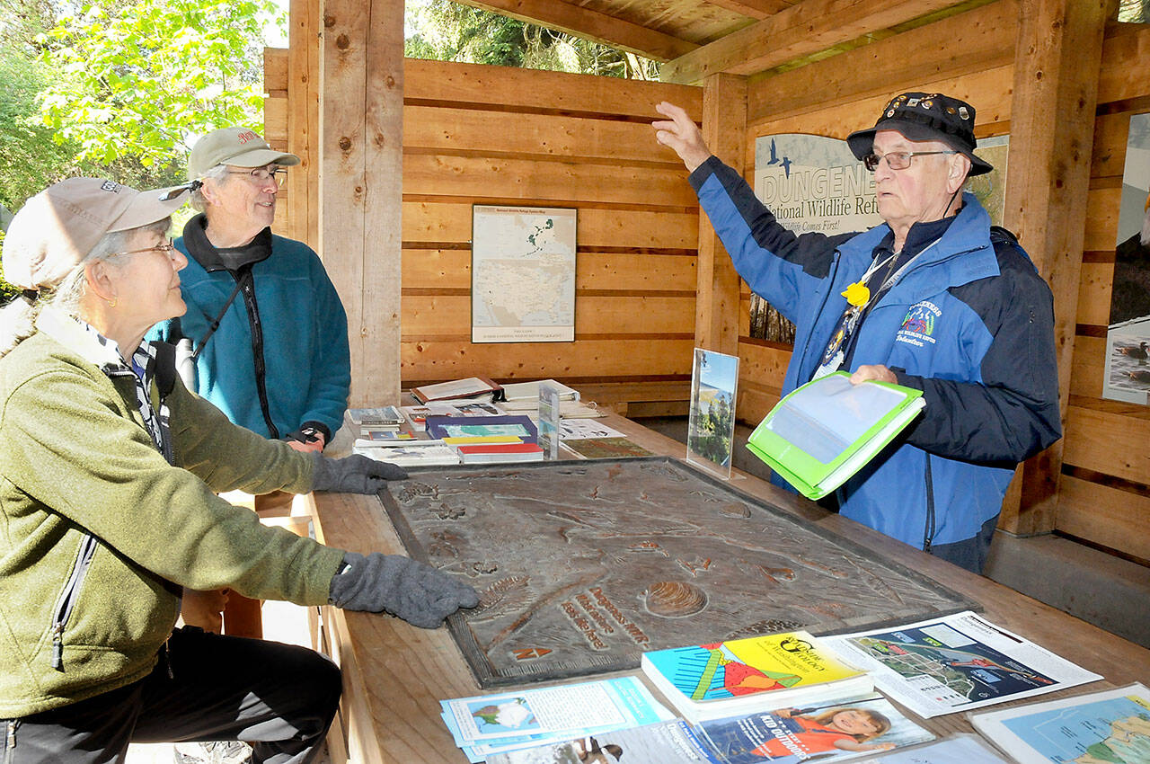 File photo by Keith Thorpe/Olympic Peninsula News Group
Martin Gutowski, a volunteer with the Dungeness National Wildlife Refuge, right, discusses features and attractions of the North Olympic Peninsula with Jan and Bob Tivel of Anacortes at the refuge’s information kiosk northwest of Sequim in May 2023. Besides being a sanctuary for birds and other wildlife, the refuge serves as gateway to the Dungeness Spit and the New Dungeness Lighthouse.