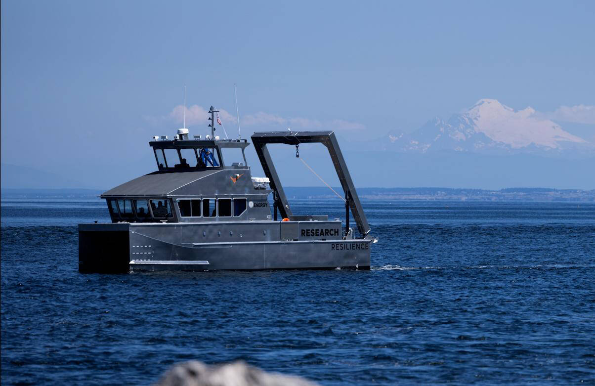 Photo by by Eric Francavilla/Pacific Northwest National Laboratory / The Department of Energy’s first hybrid research vessel, Resilience, cruises by Sequim Bay on its way to dock at the John Wayne Marina in mid-July. The vessel will operate out of the marina for a few months while PNNL-Sequim is updating its dock.