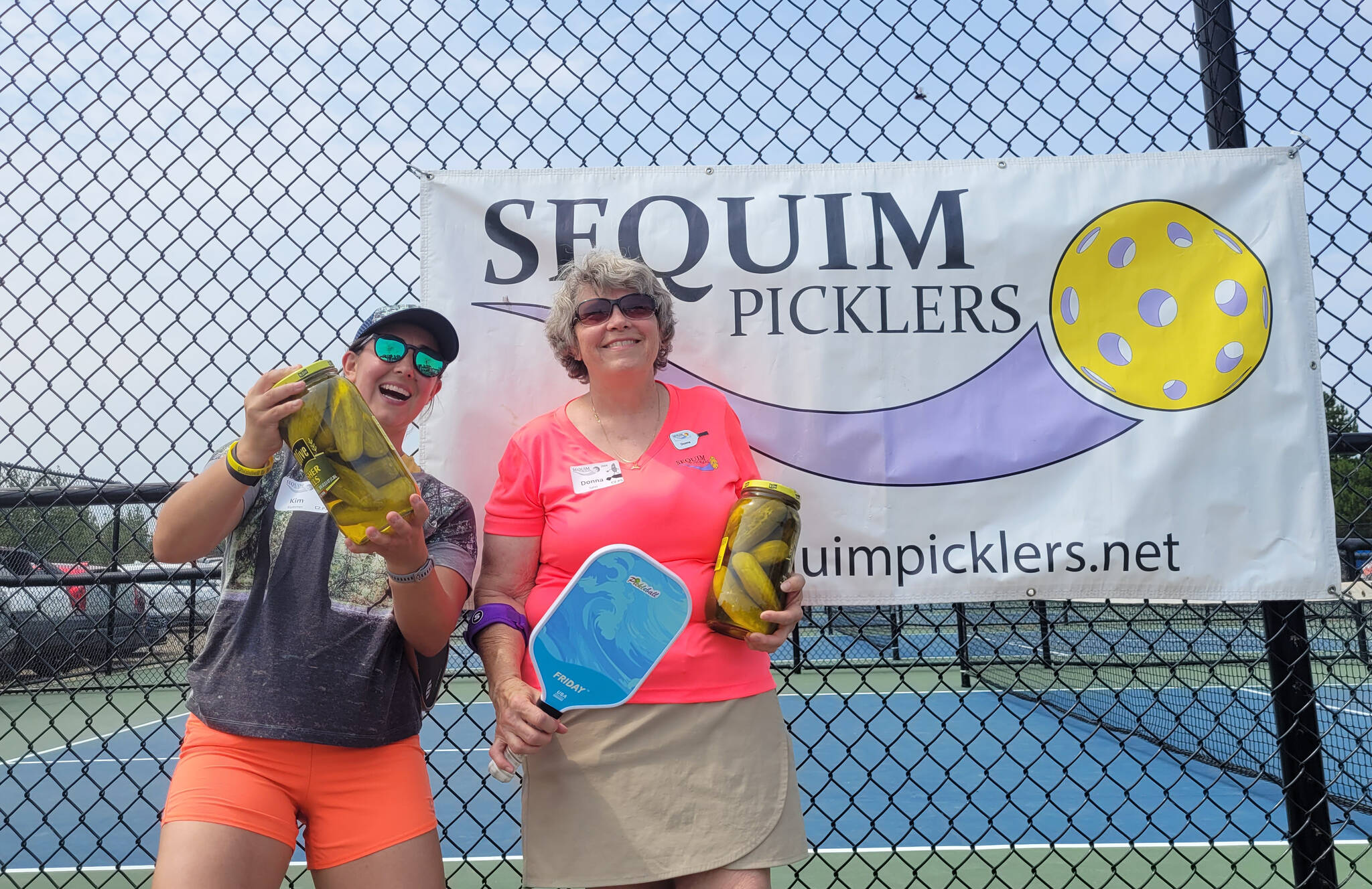 Sequim Gazette photo by Michael Dashiell
Kim Kummer, left, and Donna Salas celebrate a Big Dill pickleball tournament title at the Carrie Blake Community Park courts this past weekend.