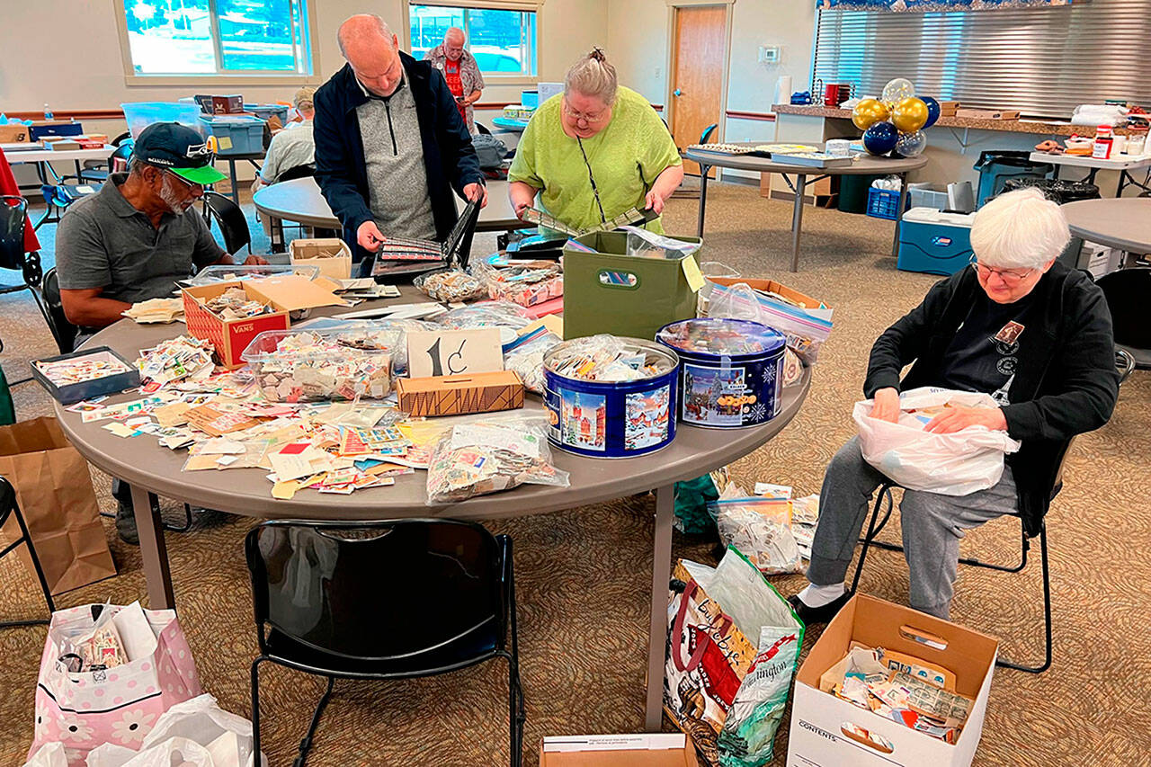 Visitors enjoy sorting through thousands of stamps at the 2023 Strait Stamp Show. The penny stamp table returns for the 30th show on Aug. 10 in the Guy Cole Event Center.