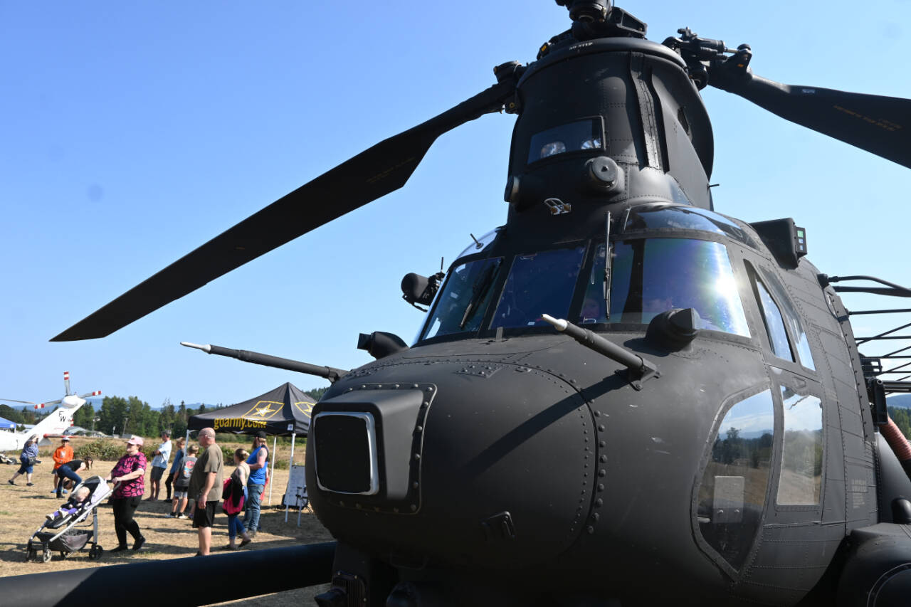 Sequim Gazette photo by Michael Dashiell / Attendees of the Unity of Effort event in Sequim on Aug. 10 get a look at an MH-47G Chinook, a U.S. Army twin-engined, tandem rotor helicopter.